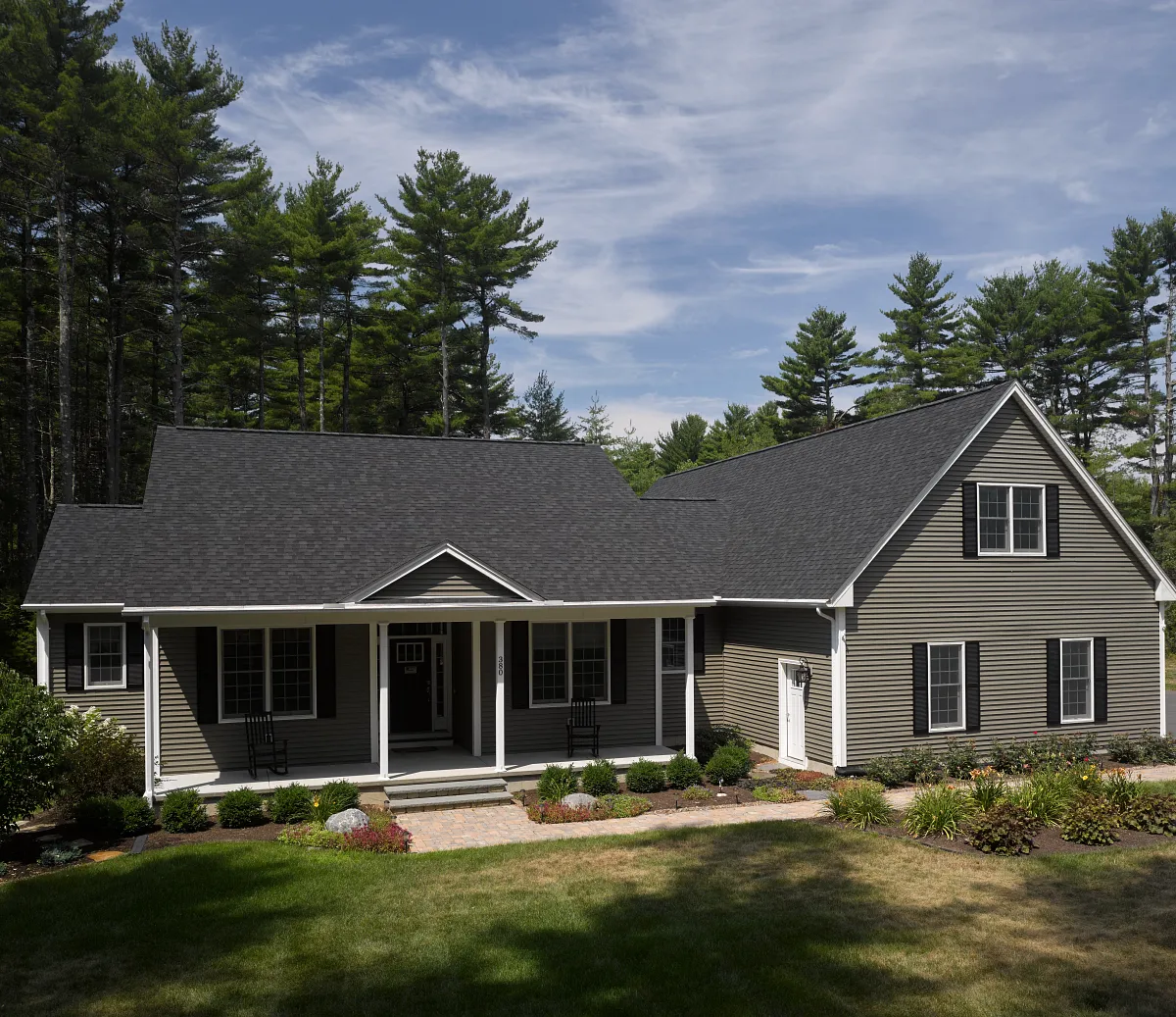 CertainTeed Landmark PRO shingles in Max Def Charcoal Black on a clay-colored house, from CertainTeed's official Landmark product page
